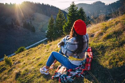 Woman sitting on mountain