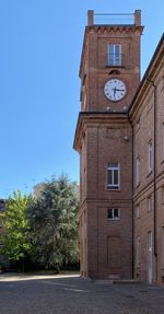 Low angle view of clock tower against sky