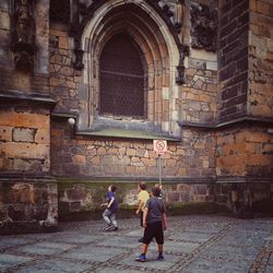 Rear view of man and woman walking in city