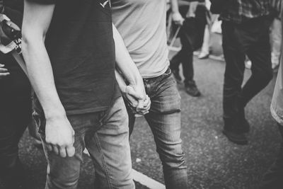 Couple holding hands while walking on street