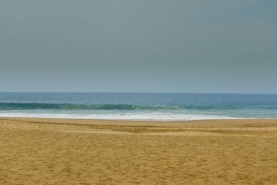 Scenic view of beach against clear sky