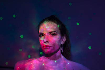 Portrait of woman against black background