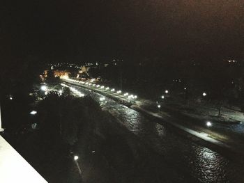 Aerial view of city lit up at night