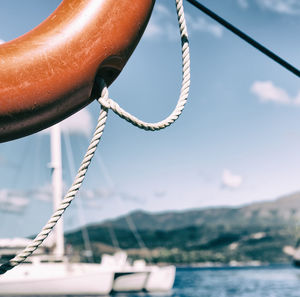 Close-up of sailboat in sea against sky