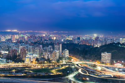 High angle view of illuminated buildings against sky at night