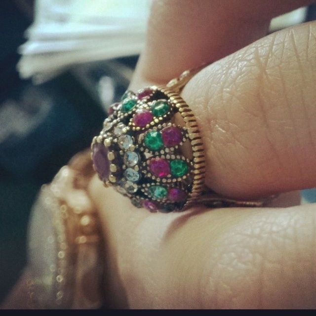 person, part of, lifestyles, close-up, indoors, leisure activity, focus on foreground, holding, fashion, jewelry, cropped, human finger, multi colored, unrecognizable person, bracelet, showing