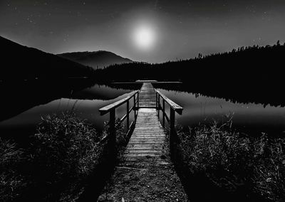 Scenic view of lake against sky at night