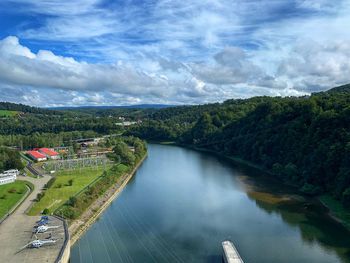 High angle view of river amidst trees against sky