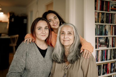 Portrait of young woman standing at home