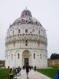 People at temple against sky