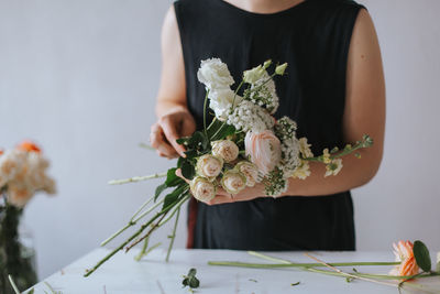 Midsection of woman holding bouquet