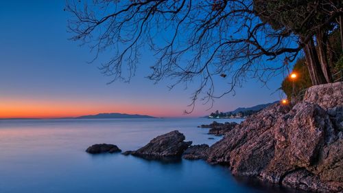 Panoramic view of sea against sky at sunset