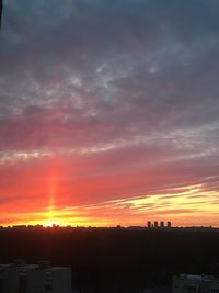 Silhouette buildings against sky during sunset