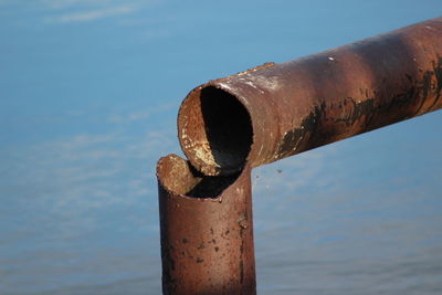 Close-up of rusty pipe against sky