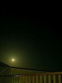 Illuminated lights against clear sky at night