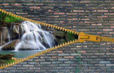 Scenic view of waterfall against wall