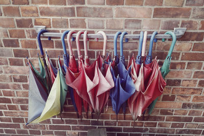 Close-up of clothes hanging on clothesline against brick wall