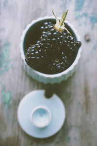 High angle view of blackberries in bowl on table