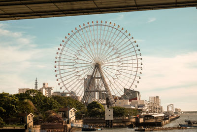 Low angle view of ferris wheel against sky