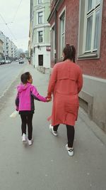 Rear view of woman standing on street