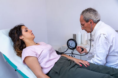 Female doctor examining patient in hospital