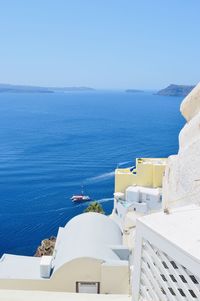 High angle view of buildings by sea against sky