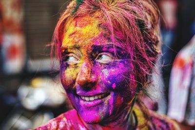 Portrait of smiling young man with powder paint on face