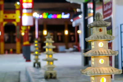 Illuminated lanterns by street light in city at night