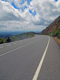 Empty road passing through landscape