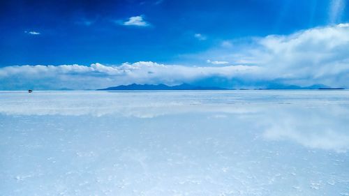 Scenic view of sea against blue sky