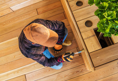 High angle view of man varnishing furniture at home