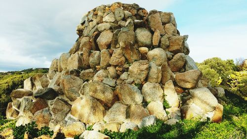 Low angle view of rock formation against sky