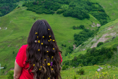 Rear view of woman with umbrella on plants