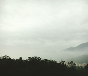 Scenic view of mountains against cloudy sky