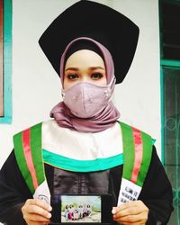 Portrait of young woman wearing mask