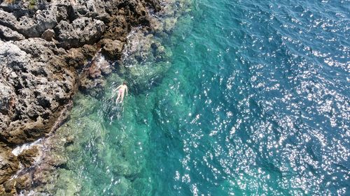 High angle view of person swimming in sea