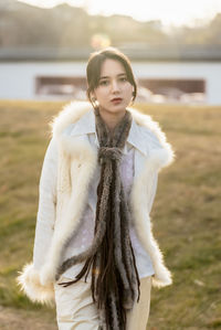 Portrait of woman standing against trees