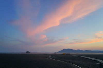 Scenic view of road against sky during sunset