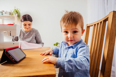 Boy and son on table at home