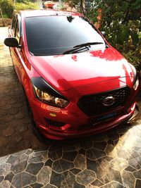 Close-up of red car parked on street