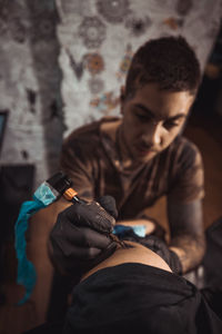 Man making tattoo at workshop