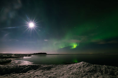 Scenic view of sea against sky at night