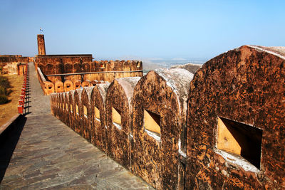 Walkway at jaigarh fort against clear blue sky