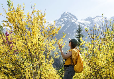 Rear view of woman standing on mountain