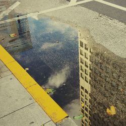 High angle view of puddle on street