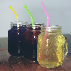 Close-up of drinks in mason jars on table