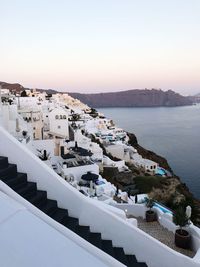 High angle view of townscape by sea against sky