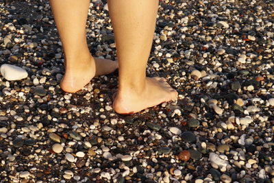Bare feet on a pebbly beach