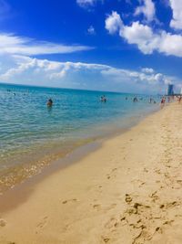 Scenic view of beach against blue sky