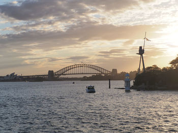 Bridge over sea against sky during sunset